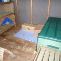 A hutch in a shed with a wall mounted heater to keep the bunnies warm in winter